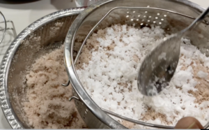 Spreading coconut to puttu podi_Instant pot Puttu-Kothiyavunu.com